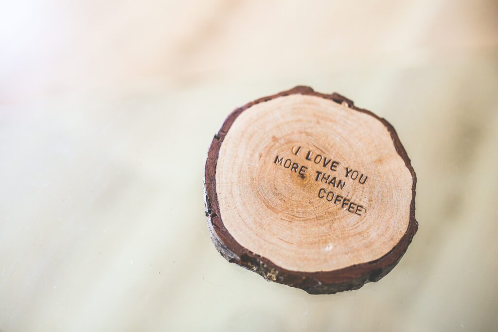 wood bark with writing : i love you more than coffee 