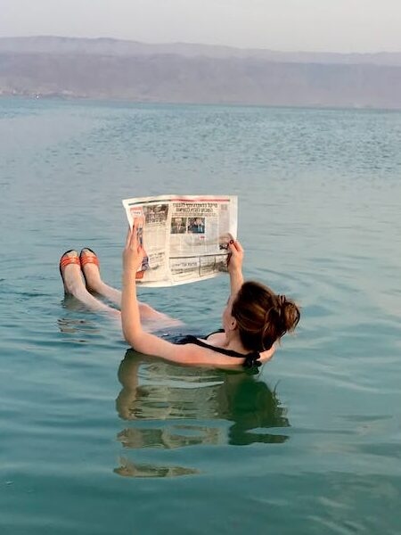 A Person Reading & Floating in the  water