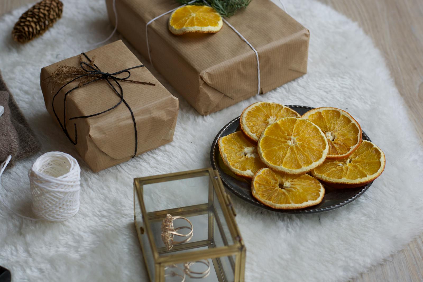 A cozy scene with sustainably wrapped gifts, dried orange slices, and rustic decorations, perfect for diy eco friendly gift inspiration.